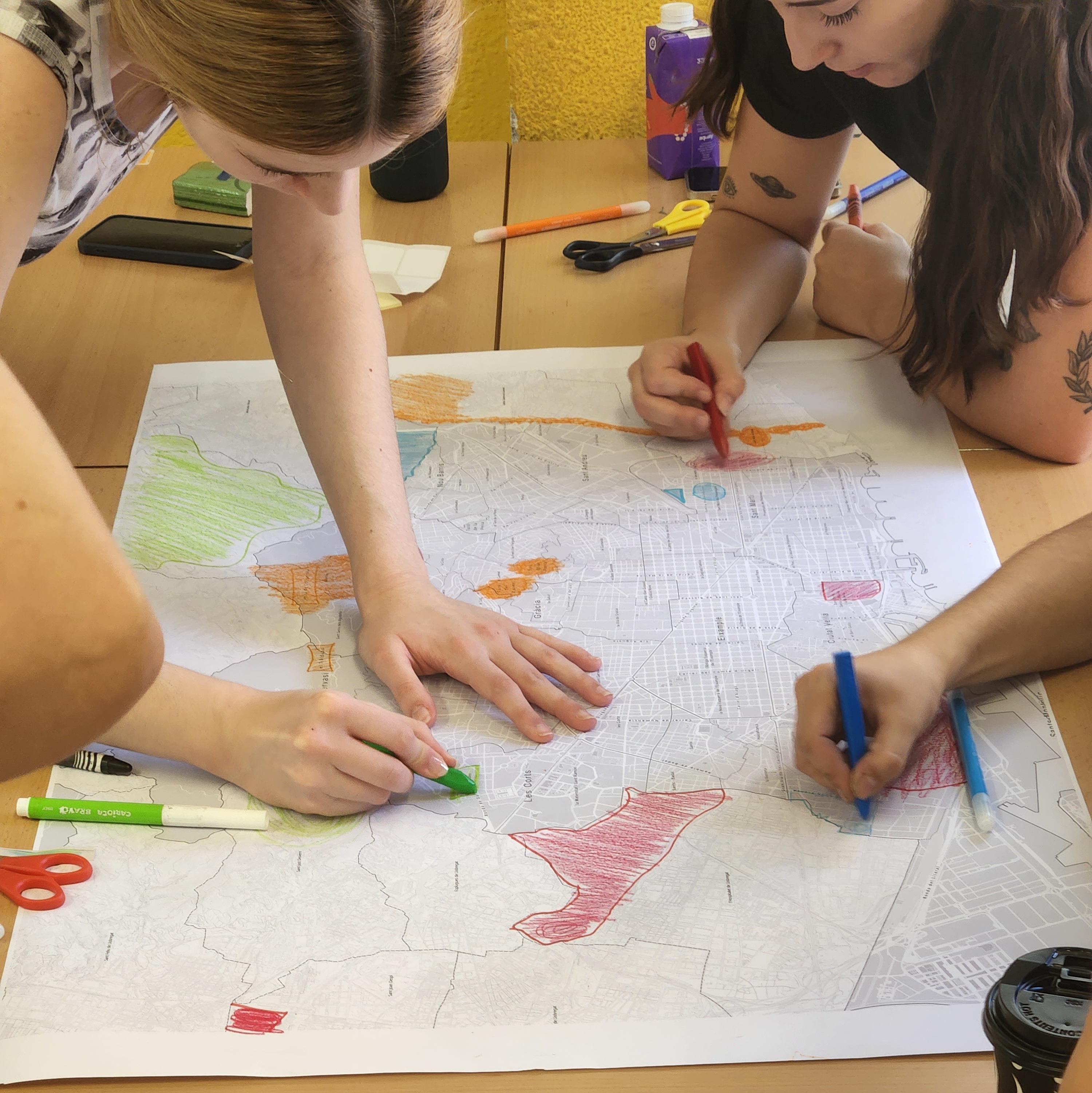 Alumnat de l'Institut Salvador Seguí pintant els punts verds de Barcelona en un mapa durant l'activitat